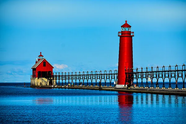 The red Grand Haven lighthouse and pier on Lake Michigan
